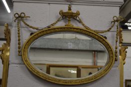An Adam Revival gilt framed oval mirror.