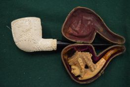 Two meerschaum pipes.