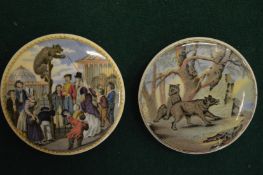 Two small pot lids, one depicting a bear the other wolves.