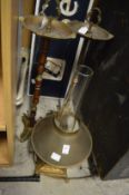 A brass lamp and two smokers stands.