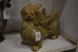 A Chinese celadon glazed model of a winged beast.