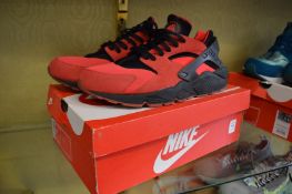 A pair of Nike Air Huarache hyper pink size 12, boxed.