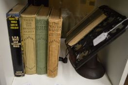A small group of books and a cast iron book stand.
