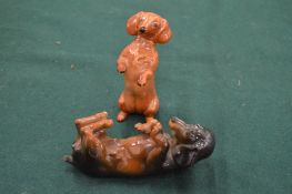 Two porcelain models of dachshunds.