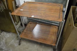 A chrome framed folding trolley.