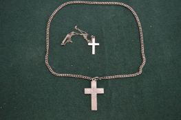 Two silver crucifixes and chains.