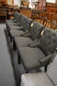 A set of six modern button upholstered dining chairs.