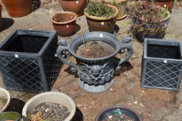 A resin urn shaped garden planter and pair of resin square shaped planters.