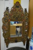 Decorative carved and polychrome decorated wall mirror in the Islamic taste.