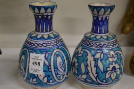 A pair of Islamic bottle vases.