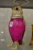 A claret jug in the form of an owl.