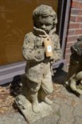 A reconstituted stone garden figure modelled as a young boy.