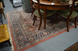 A large Persian style carpet, pink ground with floral decoration, 325cm x 245cm.