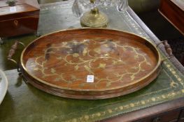 A brass inlaid mahogany oval twin handled tray.