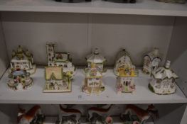Collection of ten Staffordshire pastel burner cottages and other buildings to include a water mill.