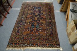 A good Persian rug, dark blue ground decorated with birds and animals, 190cm x 120cm.