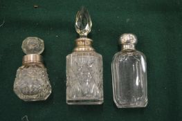 Three cut glass and silver mounted scent bottles.