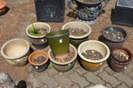A group of glazed garden plant pots.