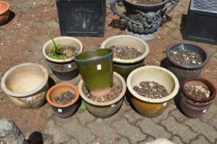 A group of glazed garden plant pots.