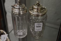 Two cut glass jars, one with silver mounts.