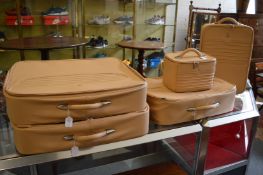 A five piece set of Maserati tan leather luggage.