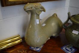 A pair of large Chinese celadon glazed recumbent goats.