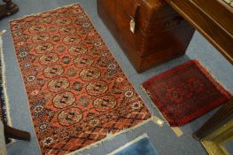 A bokhara style rug, 162cm x 83cm together with a small bokhara style mat, 60cm x 47cm.