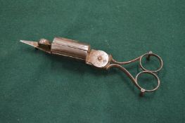 A pair of steel candle snuffers/wick trimmers.