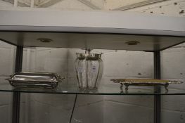 A cut glass biscuit jar with plated mounts together with a plated entree dish and cover and a cheese