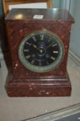 A rouge marble cased Victorian mantel clock, the dial signed J W Benson.