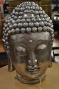 A silvered resin Buddha's head.