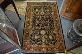 A good Persian part silk rug, dark blue ground with floral decoration, 155cm x 92cm.