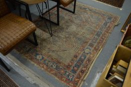 An old worn Persian rug, 175cm x 130cm.