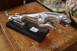 Reproduction chrome model of a Jaguar car mascot.