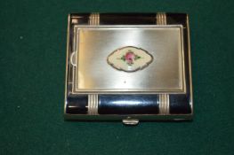 An Art Deco combination cigarette case and compact.