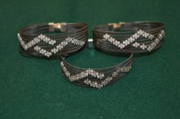 A double bracelet and a single bracelet.