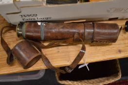Leather cased telescope and a tripod.
