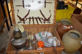 Picnic basket, oil lamp, storage jars.