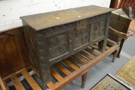 An 18th century oak coffer with carved panelled front.