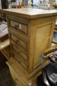 A small pine four drawer chest.