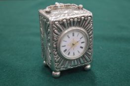 A silver carriage clock.