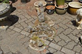 A group of three weathered reconstituted stone garden ornaments of otters.