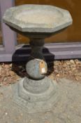 A reconstituted stone classical style pedestal bird bath.
