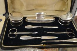 A cased silver mounted manicure set.