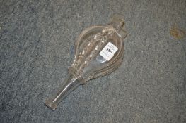 A glass bottle modelled as a pair of bellows.