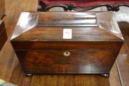 A Victorian rosewood sarcophagus shaped tea caddy.