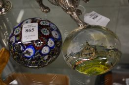 A millefiori paperweight and another paperweight.