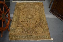 A Persian design rug, beige ground with stylised decoration, 144cm x 103cm.