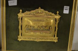 A gilt metal plaque depicting the last supper, framed and glazed.