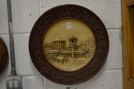 An Italian moulded pottery circular plaque.